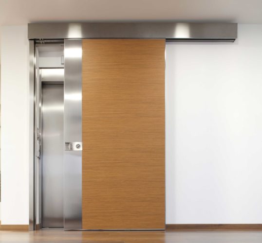 wood clad sliding door for lift access